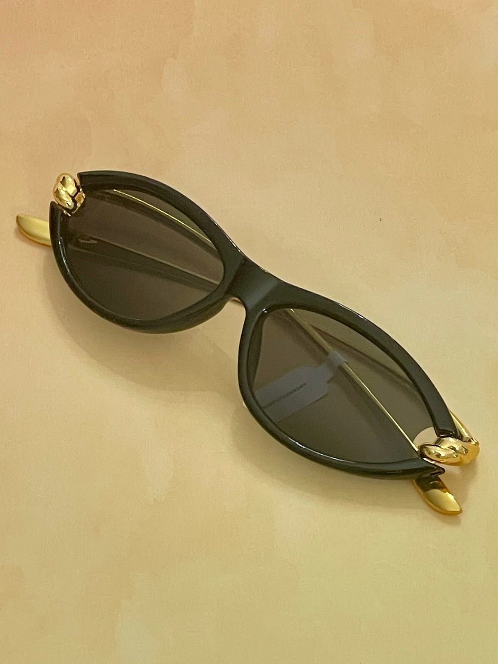 Anthropologie Black Slim Oval Cat Eye Sunglasses with Gold Metal Knotted Arms